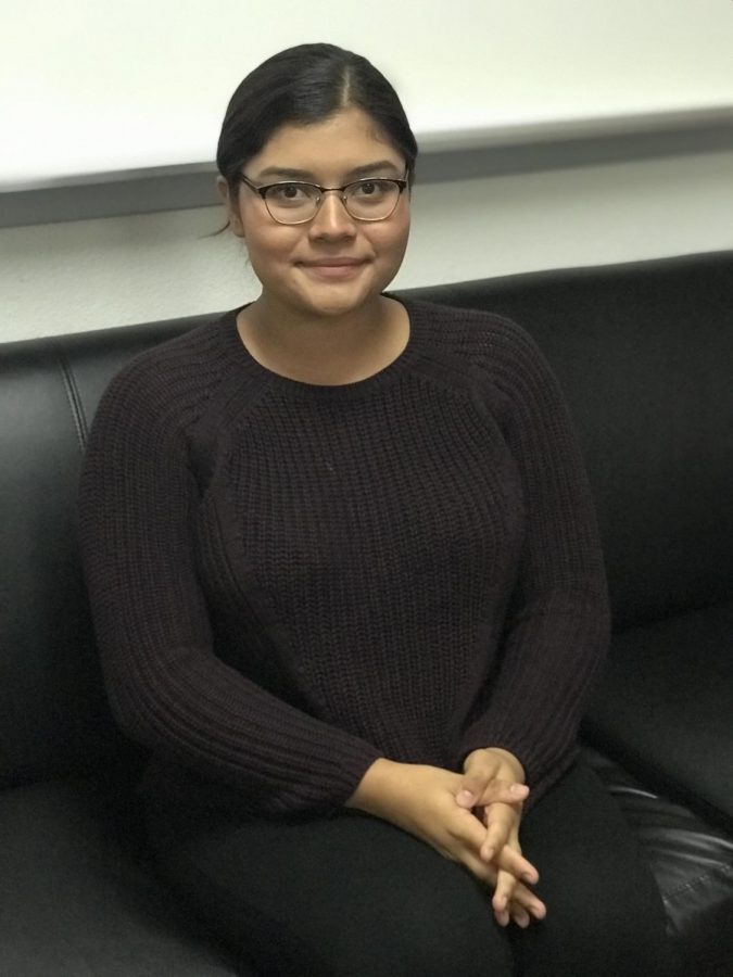 Alicia Quiroz, Mock Trial Club President, stands proudly in front of a professional space. 
