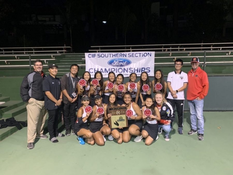 Smiling at Victory: The team holds their patches and their plaque after winning CIF. 