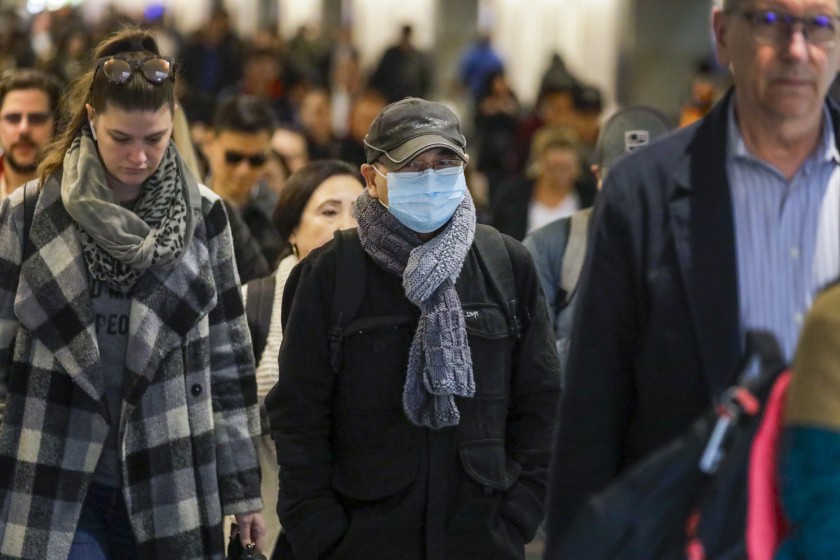 Some travelers wear masks to avoid the virus being passed on. Photo Courtesy of: Los Angeles Times 