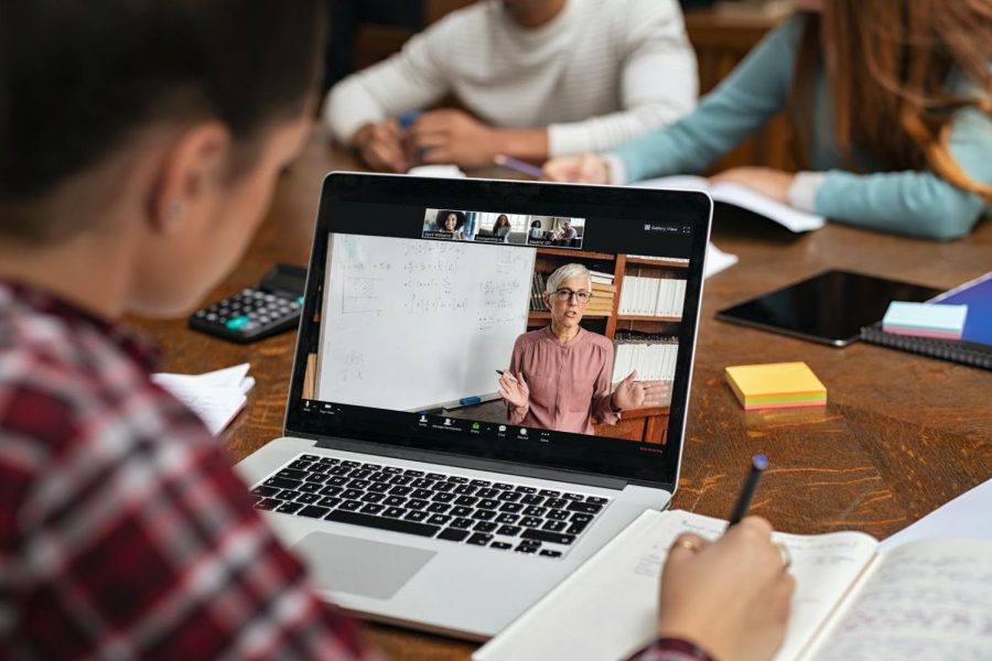 An elementary school student works hard over Zoom. Photo courtesy of: Zoom