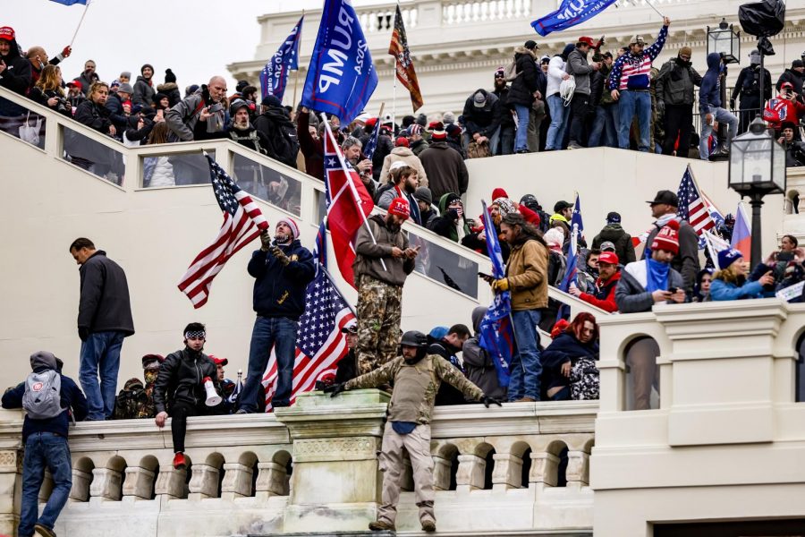 
People at the Capitol waving Trump flags in support of the ex-President’s claims. Also seen is a Confederate flag being held by a man in a Trump beanie. Photo courtesy of: NBC News