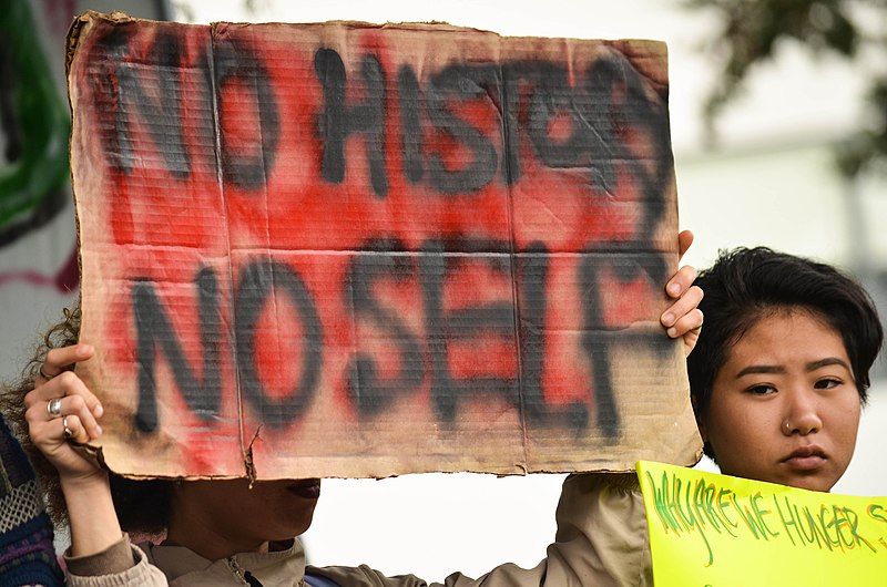 Photo Courtesy of: Melissa Minton (Wikimedia Commons)
Holding a “No History No Self” sign in support as a part of the Third World Liberation Front to defend the San Francisco State College of Ethnic Studies during a press conference on May 9, 2016.
