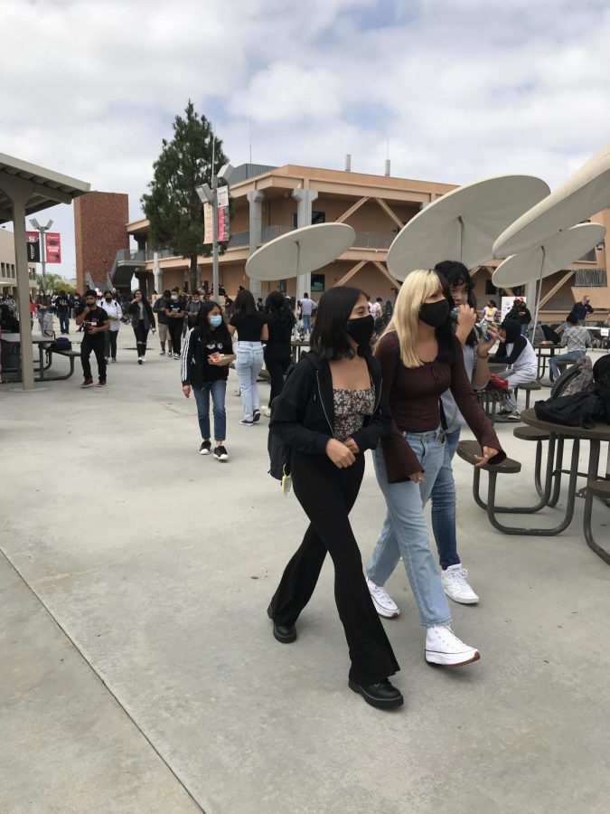 Students walk around the campus during their lunch break, following mask protocol.