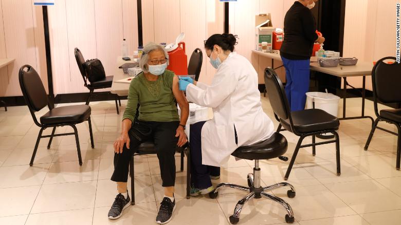 Pharmacist prepares to give her patient the Pfizer COVID-19 booster shot. (Image courtesy of CNN Health)