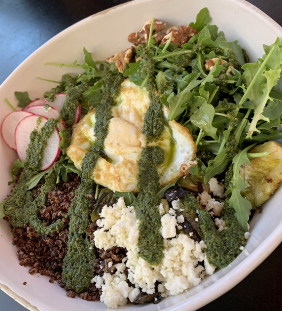 Everyday Eatery serves their delicious Green Brekkie Bowl with quinoa, egg, feta, kale, pesto, arugula, brussel sprouts, and walnuts. 