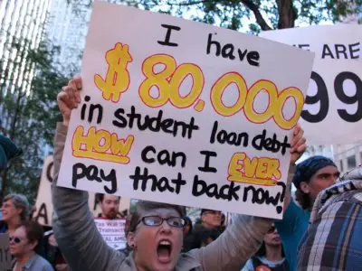 Protestors rally in favor of action on student loan debt that would alleviate their financial situations. 