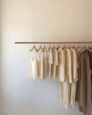 A clothing rack full of neutral colored tones.