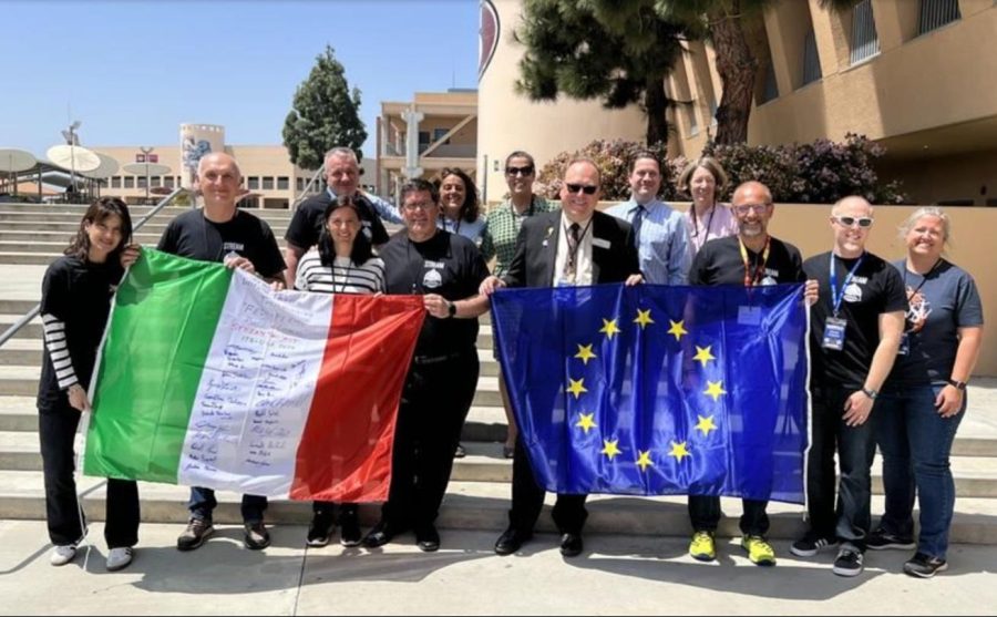 Segerstrom High School and I.T.T.S representatives stand together holding the American and European flags together.