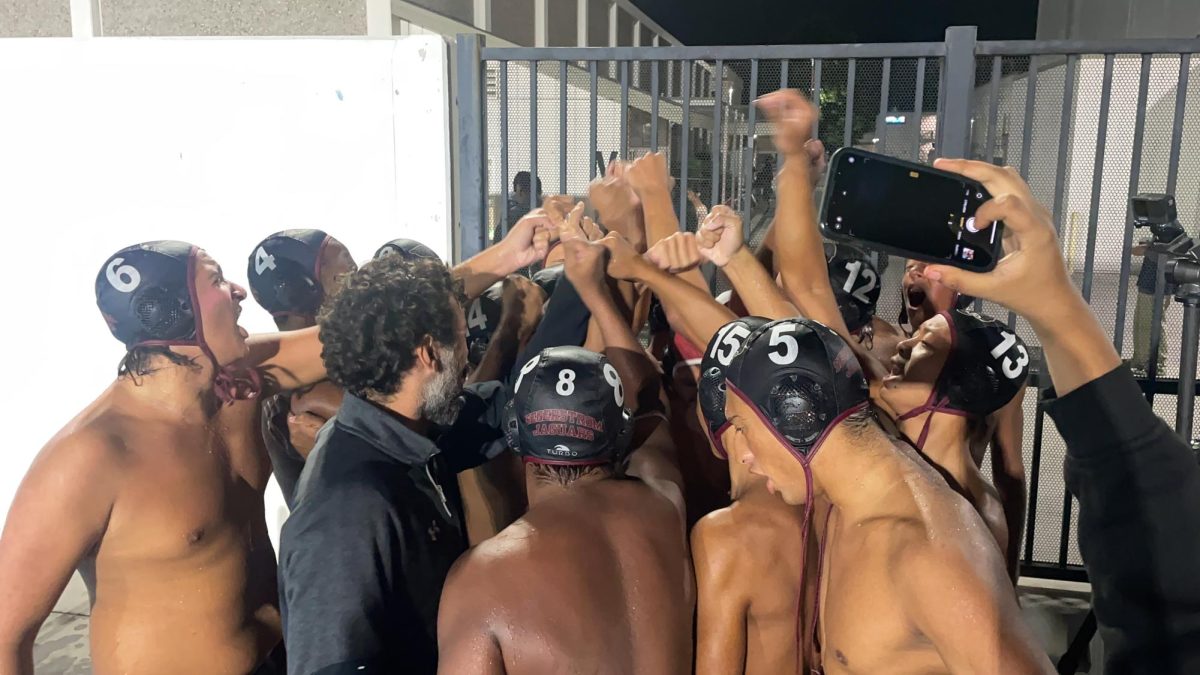 The boys varsity water polo team cheers after winning the title of Golden West League Champions.