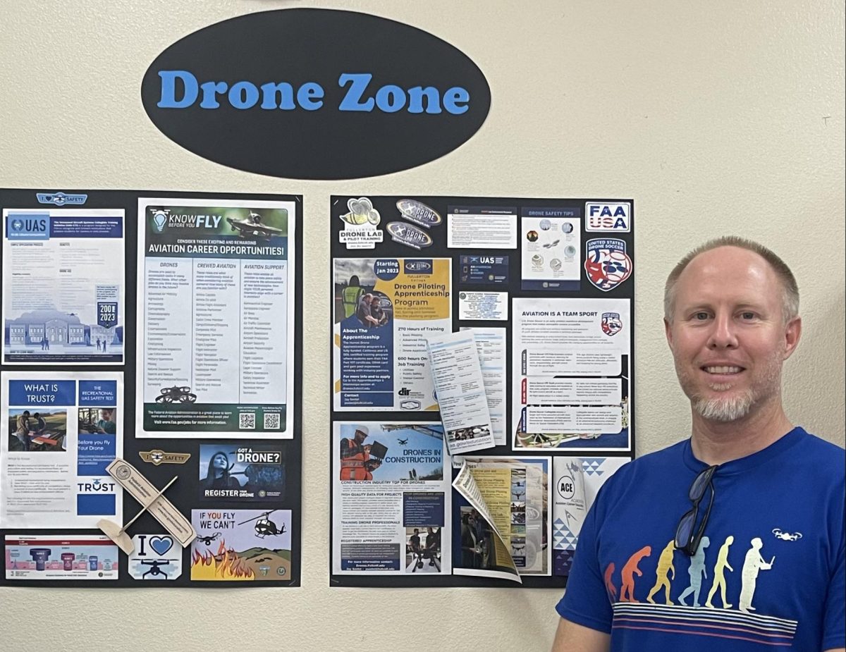 Mr. Woods stands proudly in front of his Drone Zone board.