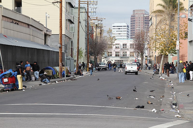 Homeless individuals in Skid Row, Los Angeles, California camped against the streets of the city. This photo shows the harsh circumstances these people face out on the streets as it could be seen in many cities around southern California.