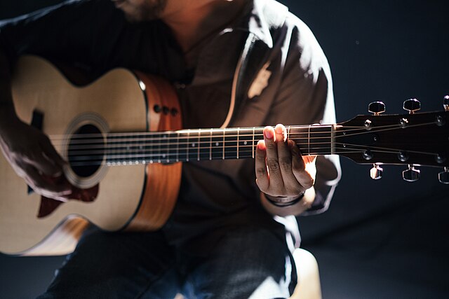 A guitar player is featured making music. Saturday's workshop will cover multiple aspects of songwriting and music. 