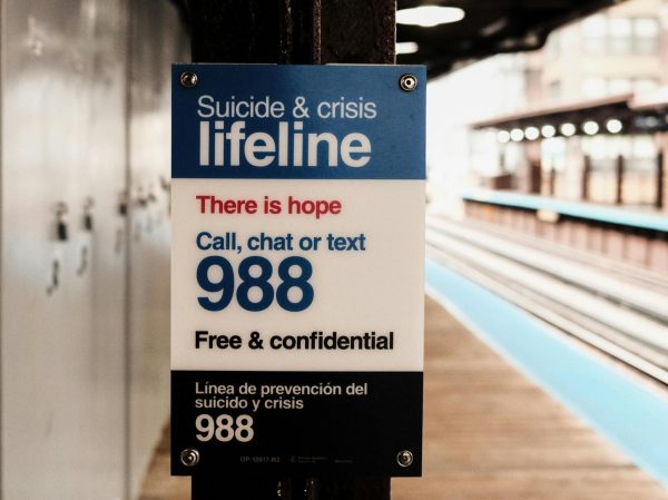 This photo shows a suicide lifeline sign, detailing the 988 number. This may be a useful resource for those in crisis situations.