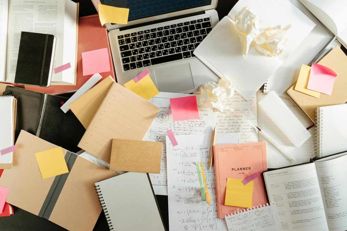 The picture illustrates paper work scattered across a desk. This is similar to the chaotic nature of college application season. 