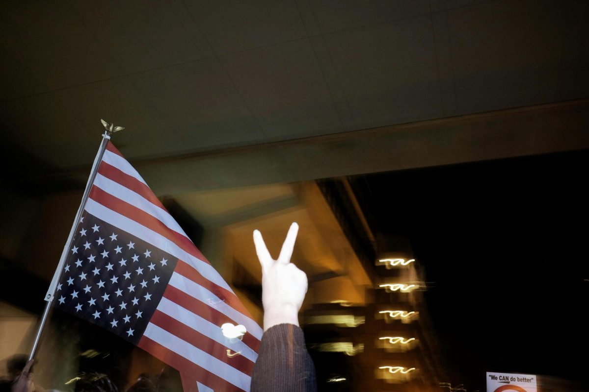 The American flag is shown upside down. This is a sign of distress in America often used in protest.