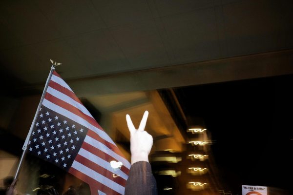 The American flag is shown upside down. This is a sign of distress in America often used in protest.