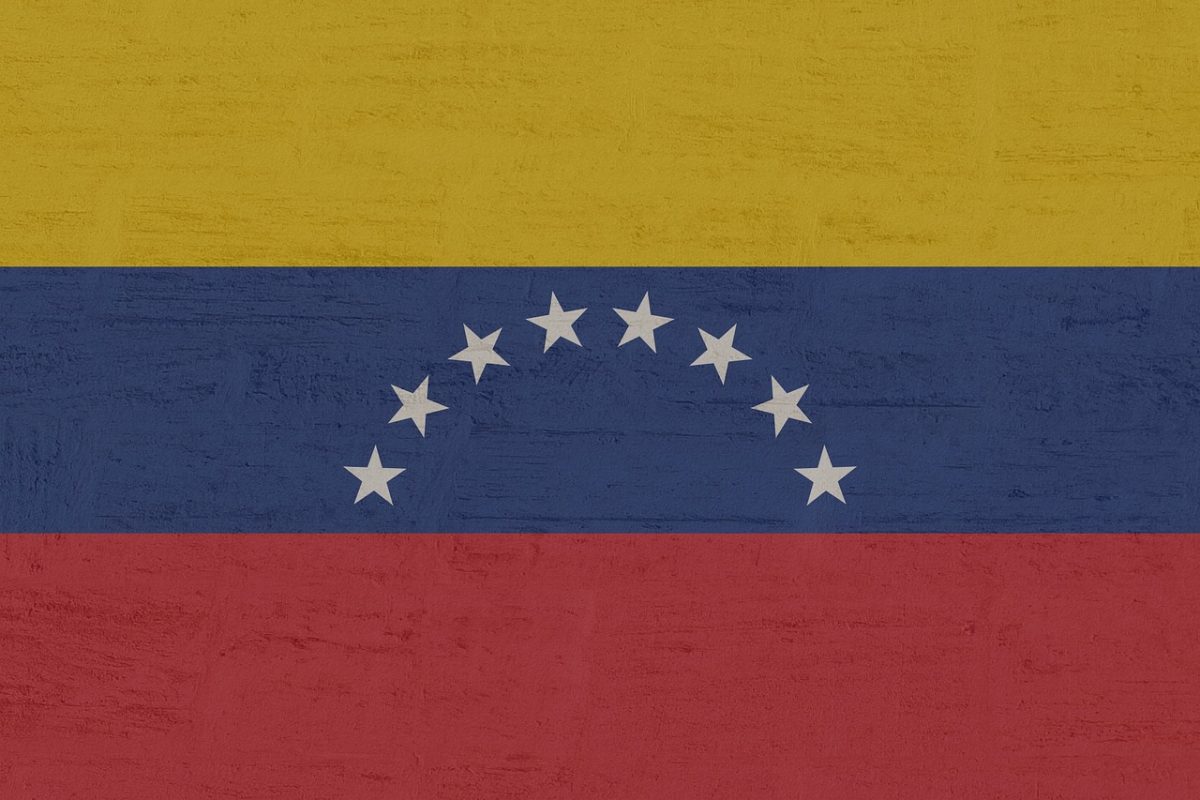 This photo shows the Venezuelan flag with a yellow, blue, and red design and silver stars going across it. This symbolizes Maduro's connection with his home country. 
