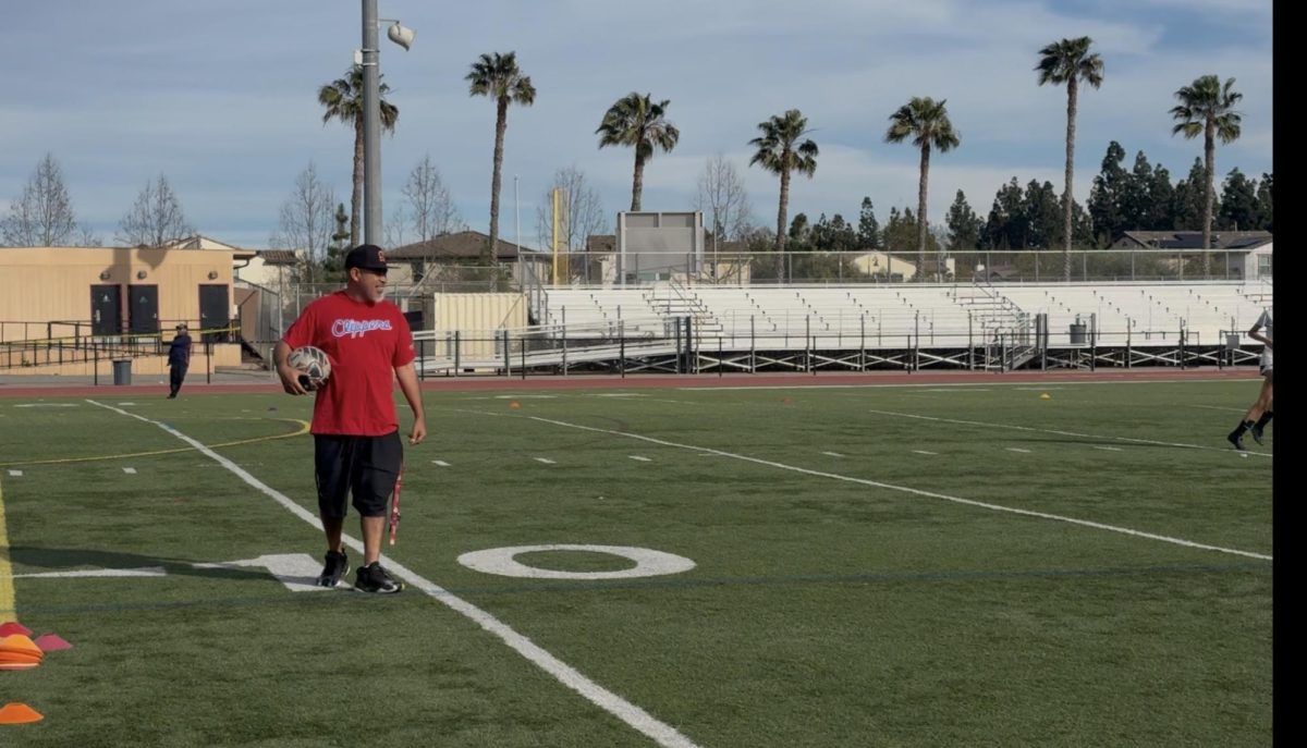 Coach Aguirre is depicted in this photo, coaching his team on their way to CIF. Coach A has put significant work into his team, the proof shown in the abilities of the athletes and them making it to CIF.