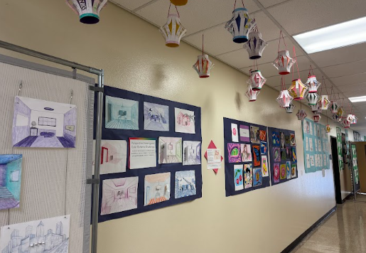This photo shows C building's hallway adorned with student's work. Work like this is eligible for Lou Correa's art competition, and we recommend students interested in art to participate. 