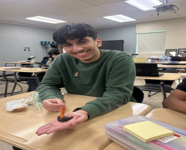 Jose poses with a "birthday cake". Our staff writer is graduating and attending SAC in the fall! 